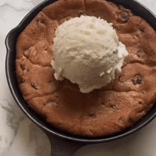 A Skillet With A Cookie And A Scoop Of Ice Cream On Top GIF