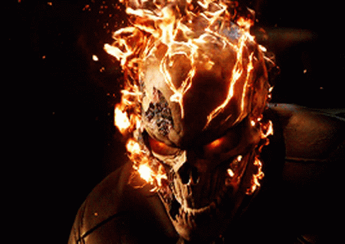 A Skull With Flames Coming Out Of It 'S Head GIF