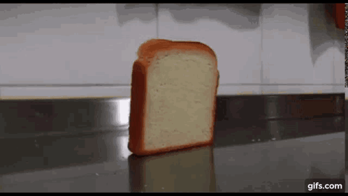 A Slice Of Bread Is Sitting On A Counter With A Gifs.com Logo In The Corner . GIF
