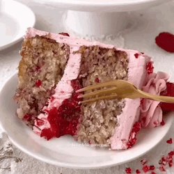 A Slice Of Cake With Pink Frosting And Strawberry Sauce On A Plate With A Fork . GIF