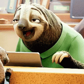 A Sloth Is Wearing A Green Shirt And Smiling While Looking At A Tablet GIF