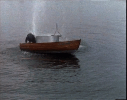 A Small Boat Is Floating On A Body Of Water And Has The Name ' Amanda ' On The Side GIF