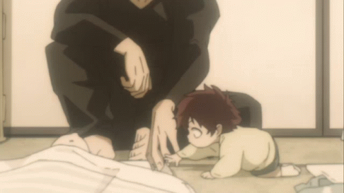 A Small Child Is Crawling On The Floor Next To A Man GIF