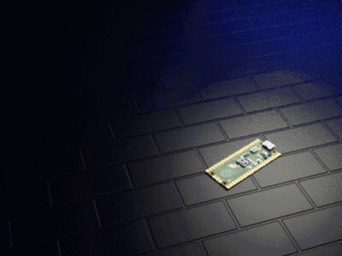 A Small Electronic Device On A Black Tile Floor GIF