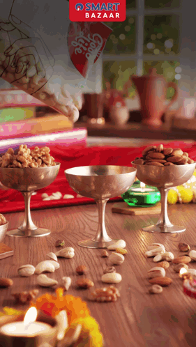A Smart Bazaar Advertisement Shows A Person Pouring Nuts Into Bowls GIF