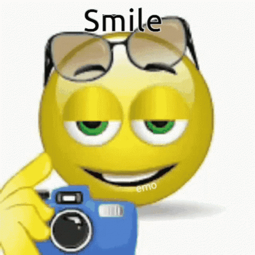 A Smiley Face Wearing Glasses Is Taking A Picture With A Blue Camera . GIF