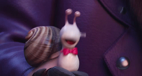A Snail Wearing A Red Bow Tie Is Being Held By A Person GIF