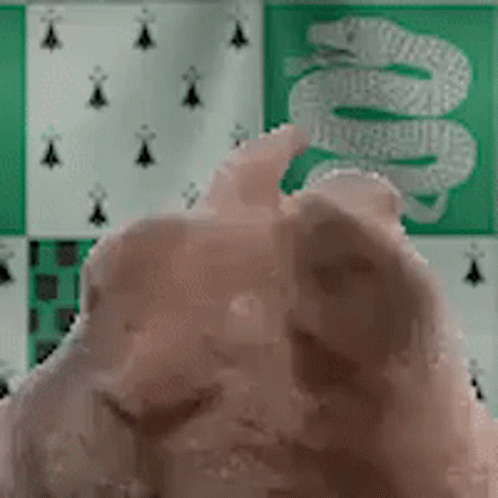 A Snake Is On A Green And White Checkered Background . GIF