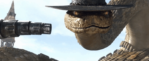 A Snake Wearing A Cowboy Hat With A Gun On Its Head GIF