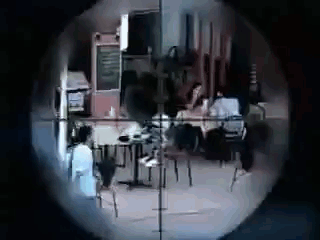 A Sniper 'S Scope Shows A Group Of People Sitting At Tables In A Restaurant . GIF