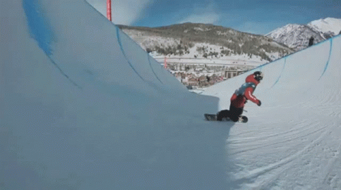 A Snowboarder Is Doing A Trick In The Air With The Letter P On His Knee GIF