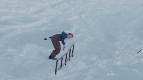 A Snowboarder Is Doing A Trick With The Word Burton On The Board GIF