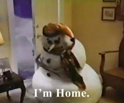 A Snowman In A Living Room With The Words " I 'M Home " Below It GIF