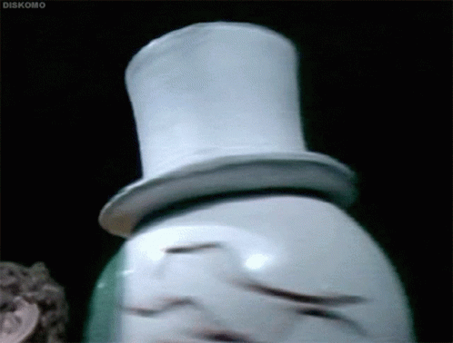 A Snowman Wearing A Top Hat Is Standing In A Dark Room . GIF