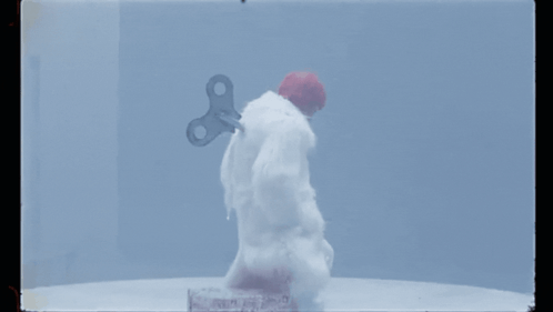 A Snowman With A Wind Up Key On His Back GIF