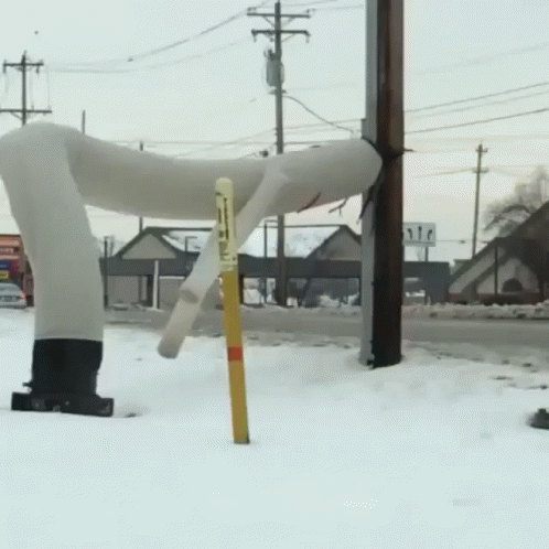 A Snowy Street With A Sign That Says ' Stop ' On It GIF