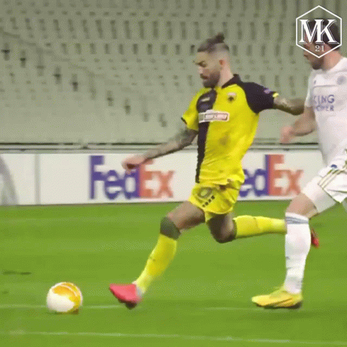A Soccer Ball Is Being Kicked On A Field With A Fedex Ad In The Background . GIF