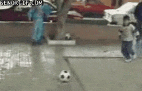A Soccer Ball Is Being Kicked On A Sidewalk With A Senorgif.com Watermark GIF