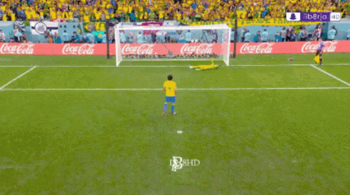 A Soccer Field With Coca Cola Advertisements On The Walls GIF