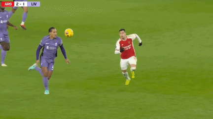 a soccer game is being played and the score is 2 to 1