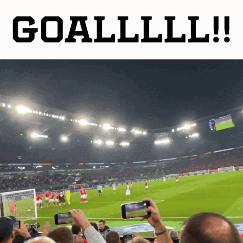 A Soccer Game Is Being Played In A Stadium And People Are Taking Pictures Of It GIF