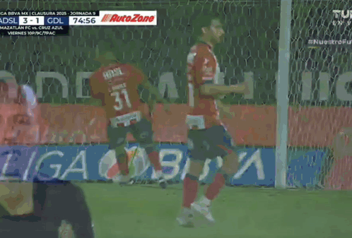 a soccer game is being played in a stadium and the score is 3 to 1