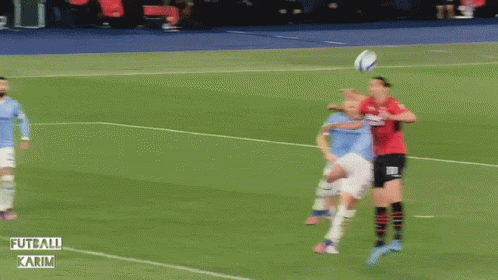 A Soccer Game Is Being Played In A Stadium That Says Futball Karim On The Side GIF