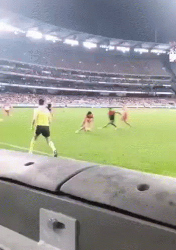 A Soccer Game Is Being Played In A Stadium With People Playing On The Field . GIF