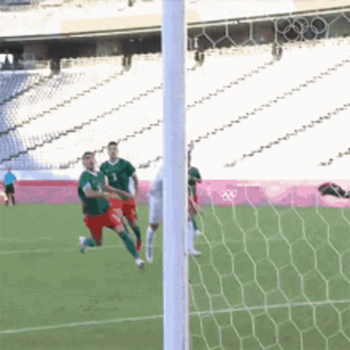 A Soccer Game Is Being Played In A Stadium With The Olympics Logo In The Background GIF