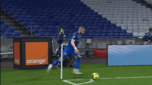 a soccer game is being played in an empty stadium with emirates fly better advertisements on the sidelines