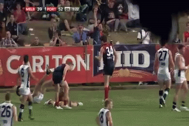 A Soccer Game Is Being Played In Front Of A Banner That Says Carlton Id GIF