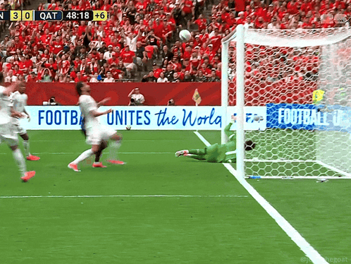 a soccer game is being played in front of a banner that says " football unites the world "