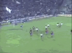 a soccer game is being played in front of a banner that says itman gm