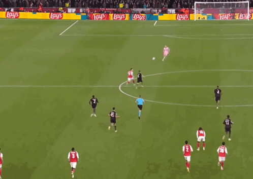 a soccer game is being played in front of a banner that says lay 's