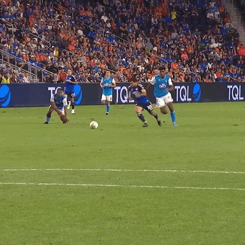 A Soccer Game Is Being Played In Front Of A Banner That Says Tol GIF
