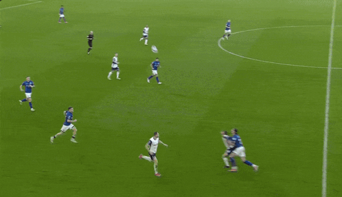 a soccer game is being played in front of a crowd and a scoreboard that says premier league on it