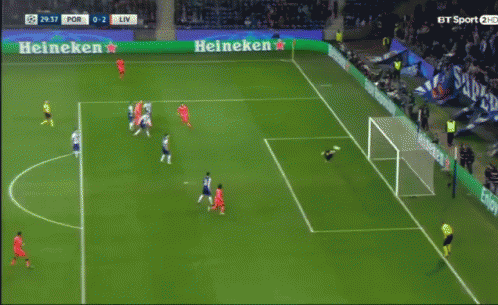 a soccer game is being played in front of a heineken sign