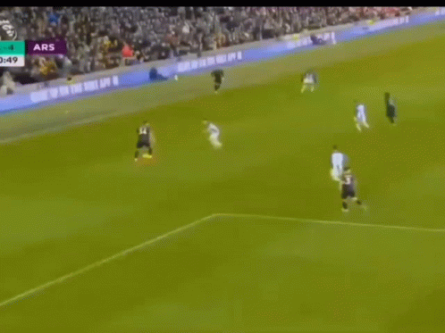 a soccer game is being played in front of a large crowd and the score is ars 4 to 4