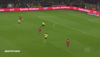 a soccer game is being played in front of a large flyeralarm banner