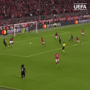 a soccer game is being played in front of a mastercard ad