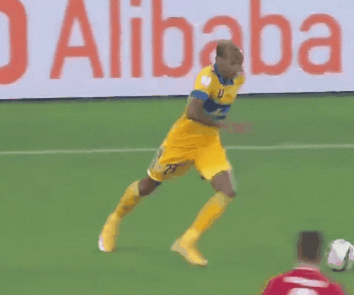 a soccer game is being played in front of a sign that says alibaba cloud