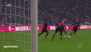 a soccer game is being played in front of a sign that says magenta