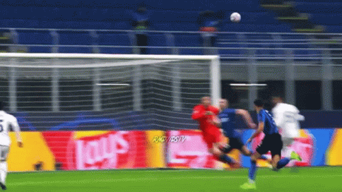 a soccer game is being played in front of an ad for lays chips