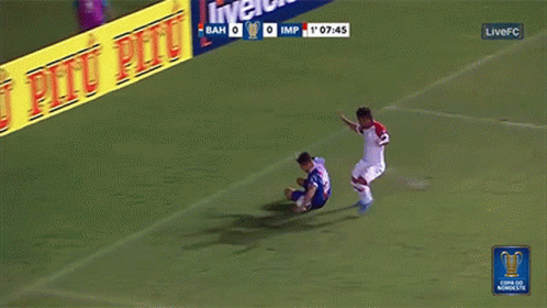a soccer game is being played in front of an advertisement for pitu pitu