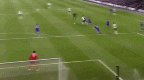 A Soccer Game Is Being Played On A Field And A Goalie Is Diving To Save A Goal . GIF