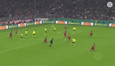 a soccer game is being played on a field that has advertisements for bitburger