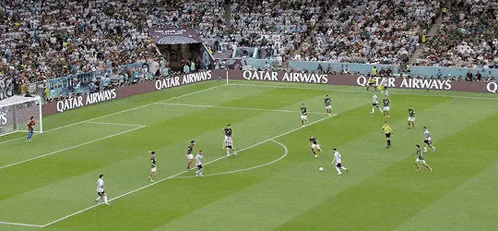a soccer game is being played on a field that has qatar energy written on the sidelines