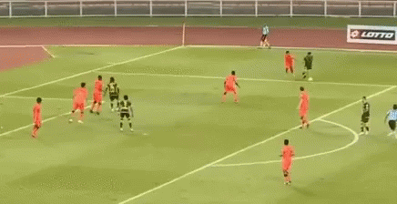 A Soccer Game Is Being Played On A Field With A Banner Behind The Goal That Says Bell GIF