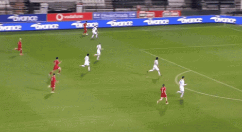 A Soccer Game Is Being Played On A Field With A Banner That Says Avance On It GIF
