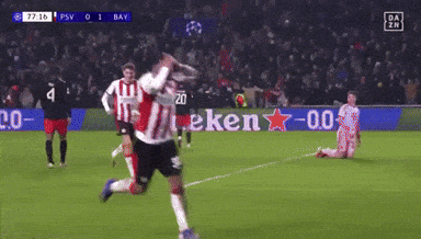 a soccer game is being played on a field with a heineken sign in the background
